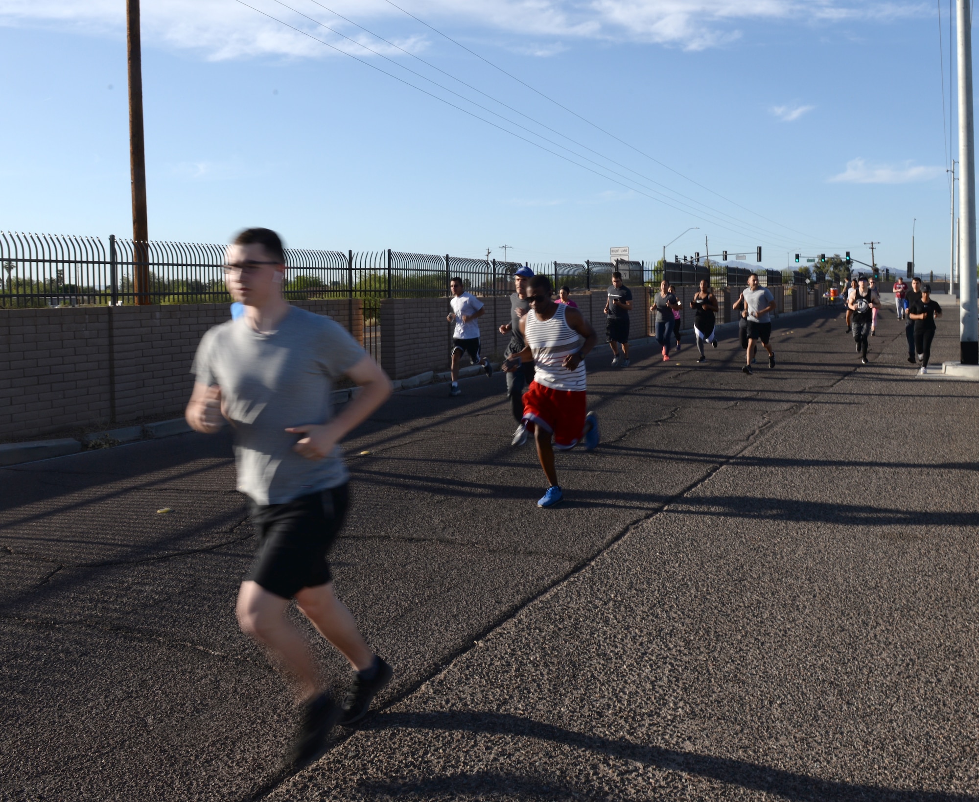 An individual runs during the Air Force Assistance Fund 5-kilometer Fun Run May 11, 2018, at Luke Air Force Base, Ariz. The run began at the base track, looped through the residential area of the base, and returned to the track. Created in 1957, the annual six-week campaign raises money for charitable affiliates that provide support to Airmen and their families in times of financial need. (U.S. Air Force photo by Senior Airman Ridge Shan)