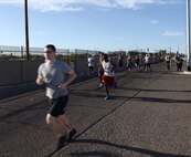 An individual runs during the Air Force Assistance Fund 5-kilometer Fun Run May 11, 2018, at Luke Air Force Base, Ariz. The run began at the base track, looped through the residential area of the base, and returned to the track. Created in 1957, the annual six-week campaign raises money for charitable affiliates that provide support to Airmen and their families in times of financial need. (U.S. Air Force photo by Senior Airman Ridge Shan)
