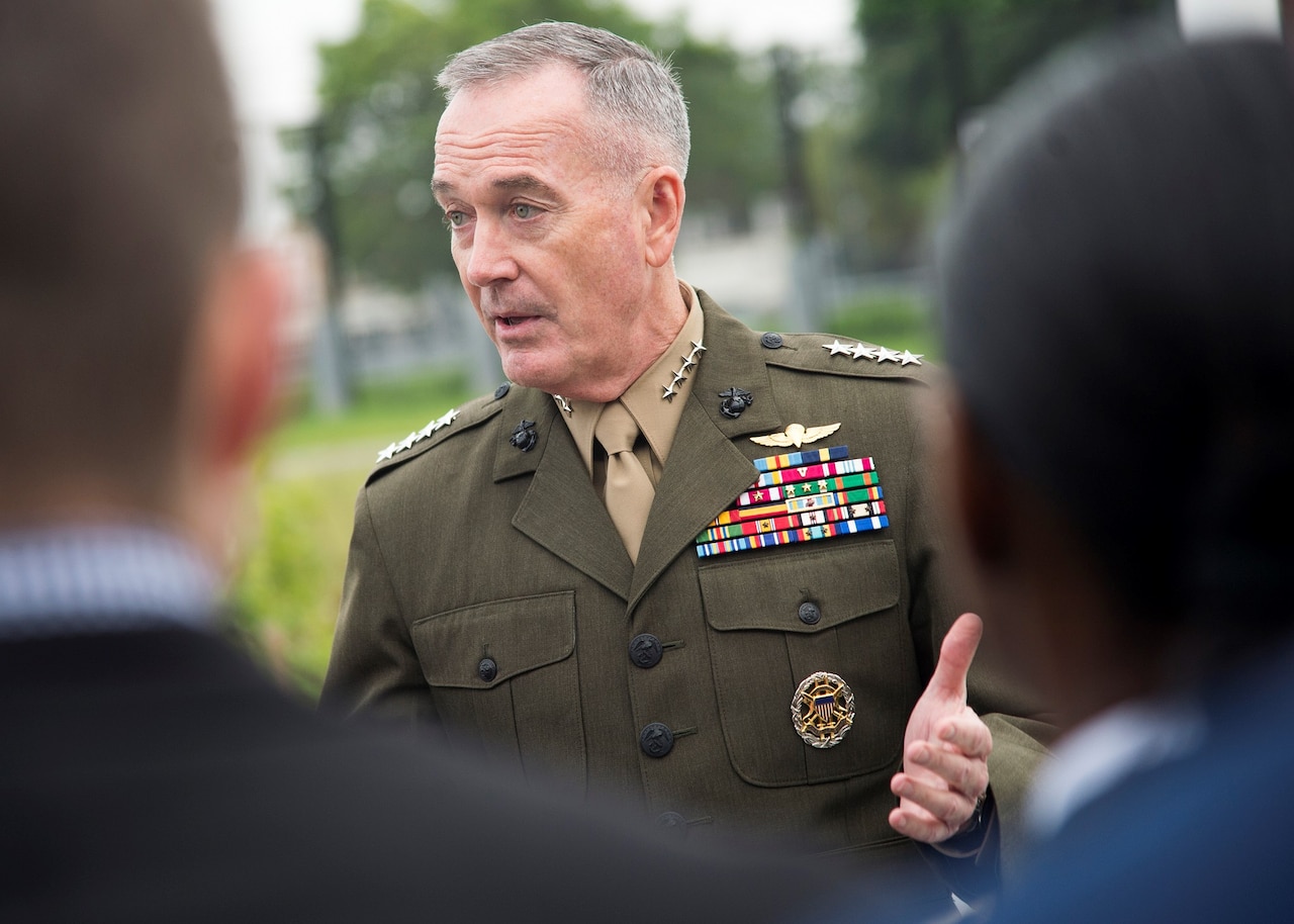 Chairman of the Joint Chiefs of Staff speaks with officers.