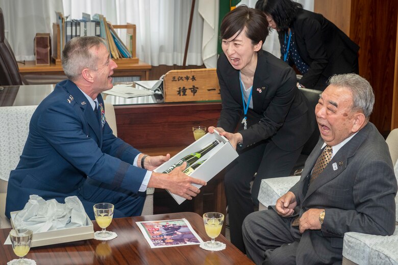 Mutsumi Kudo, center, City of Misawa Military Base Relations Division translator, hands U.S. Air Force Gen. Terrence J. O’Shaughnessy, left, Pacific Air Forces commander, a gift as Misawa City Mayor Kazumasa Taneichi, right, watches during the general’s visit to Misawa Air Base, Japan, at the city office in Misawa City, Japan, May 10, 2018. The general reassured Taneichi of PACAF’s commitment to Misawa, recalling his time as commander and the ‘two cultures--one community’ approach to life in Misawa, which remains in existence today. O’Shaughnessy said strengthening the command’s alliances and partnerships is a strategic priority. (U.S. Air Force photo by Tech. Sgt. Benjamin W. Stratton)