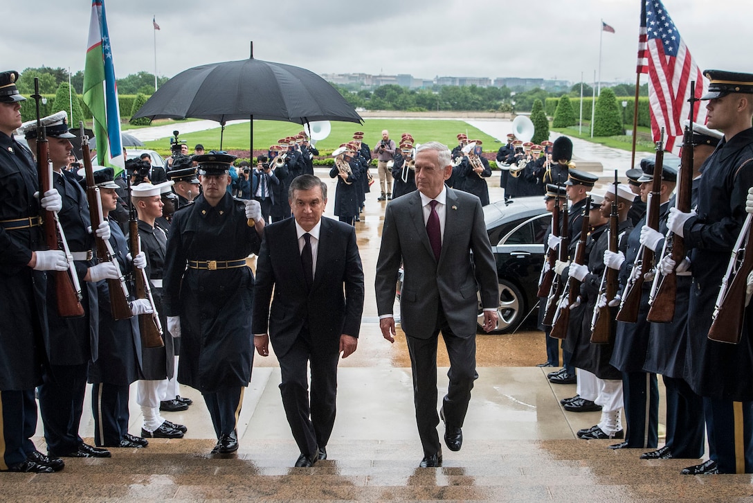 Defense Secretary James N. Mattis and a foreign leader walk up the steps of the Pentagon..
