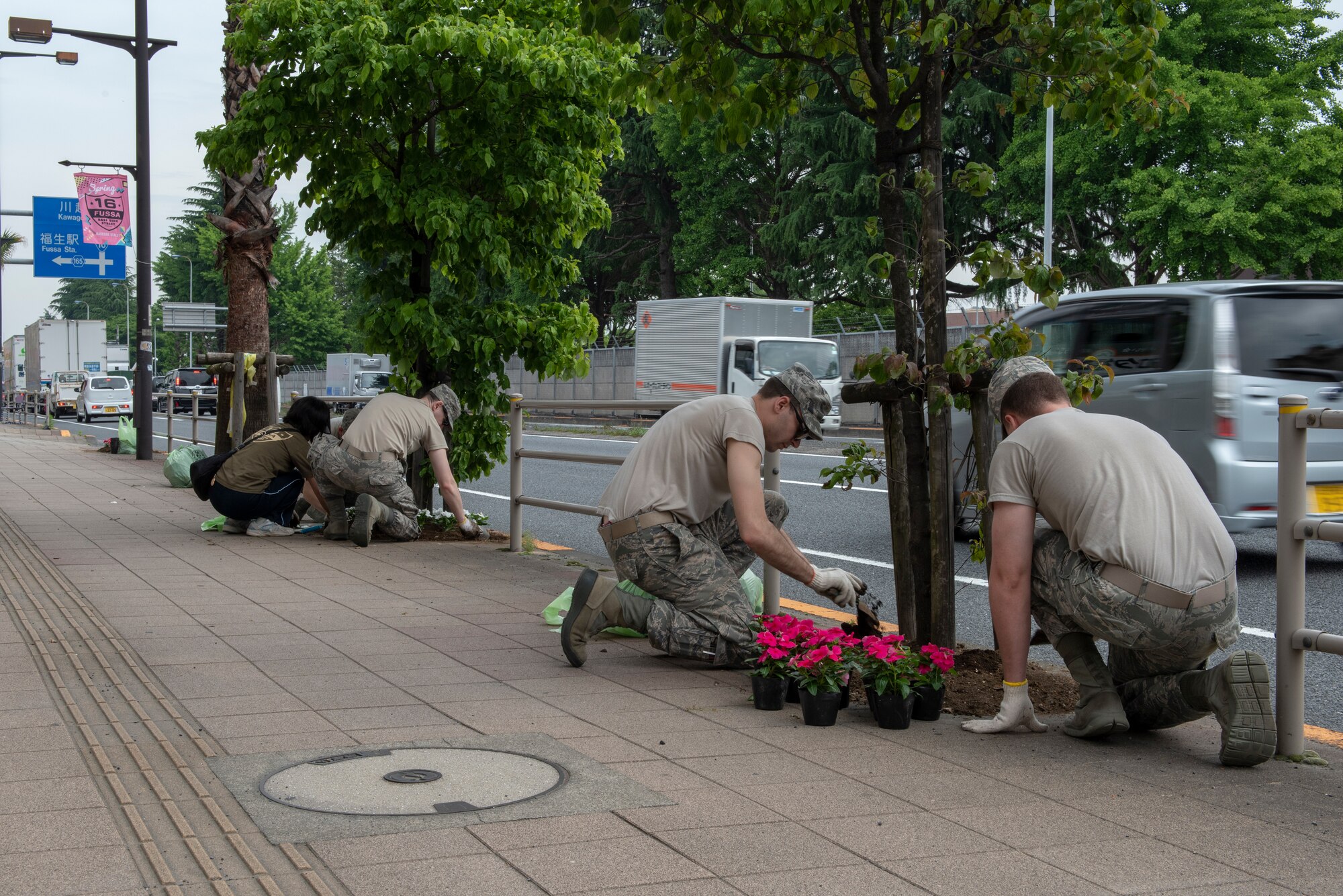 Airmen from the 374th Communications Squadron Operations Flight work with volunteers from the local community to plant flowers for the Fussa Beautification Project outside of Yokota Air Base, Japan in Fussa May 17, 2018.