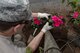 Staff Sgt. Walter Voner, 374 Communications Squadron Operations Flight client systems technician craftsman, plants a flower for the Fussa Beautification Project outside of Yokota Air Base, Japan in Fussa May 17, 2018.