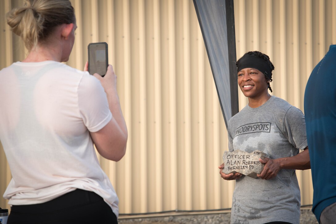 Members from Al Dhafra Air Base participate in a 5k run and ruck march in honor of National Police Week on Al Dhafra Air Base, United Arab Emirates, May 18, 2018. Participants carried bricks with names of fallen security forces officers.