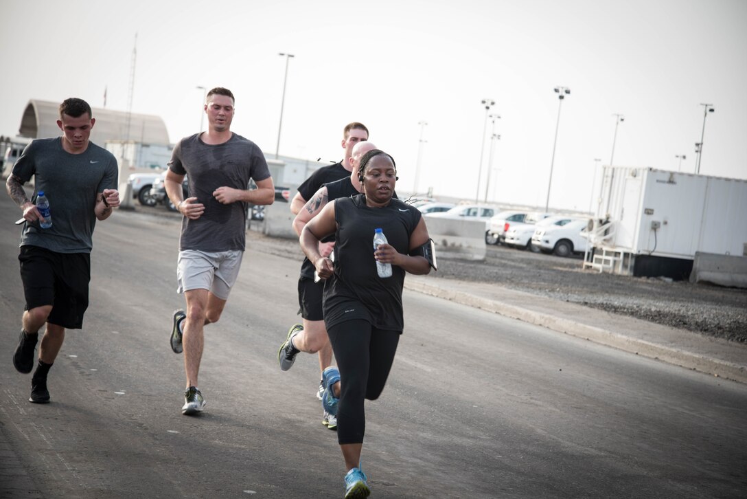 Members from Al Dhafra Air Base participate in a 5k run and ruck march in honor of National Police Week on Al Dhafra Air Base, United Arab Emirates, May 18, 2018. Participants carried bricks with names of fallen security forces officers.