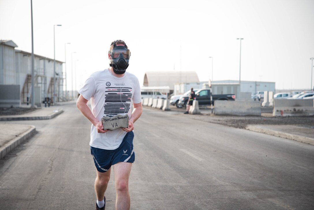 Members from Al Dhafra Air Base participate in a 5k run and ruck march in honor of National Police Week on Al Dhafra Air Base, United Arab Emirates, May 18, 2018. Participants carried bricks with names of fallen security forces officers.