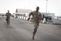 Members from Al Dhafra Air Base participate in a 5k run and ruck march in honor of National Police Week on Al Dhafra Air Base, United Arab Emirates, May 18, 2018. Participants carried bricks with names of fallen security forces officers.