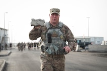 Members from Al Dhafra Air Base participate in a 5k run and ruck march in honor of National Police Week on Al Dhafra Air Base, United Arab Emirates, May 18, 2018. Participants carried bricks with names of fallen security forces officers.