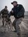 U.S. Air Force Staff Sgt. Carmen Pontello, a Security Forces Squadron military working dog handler releases as his K-9 partner Max, as he bites the protected padded arm of Tech. Sgt. Brandon Odurkirk during a bite training exercise at Al Dhafra Air Base, United Arab Emirates, May 14, 2018. Sgt. Pontello is in the process of adopting Max this year marking 11 years of faithful military service. (U.S. Air National Guard photo by: Tech. Sgt. Nieko Carzis)