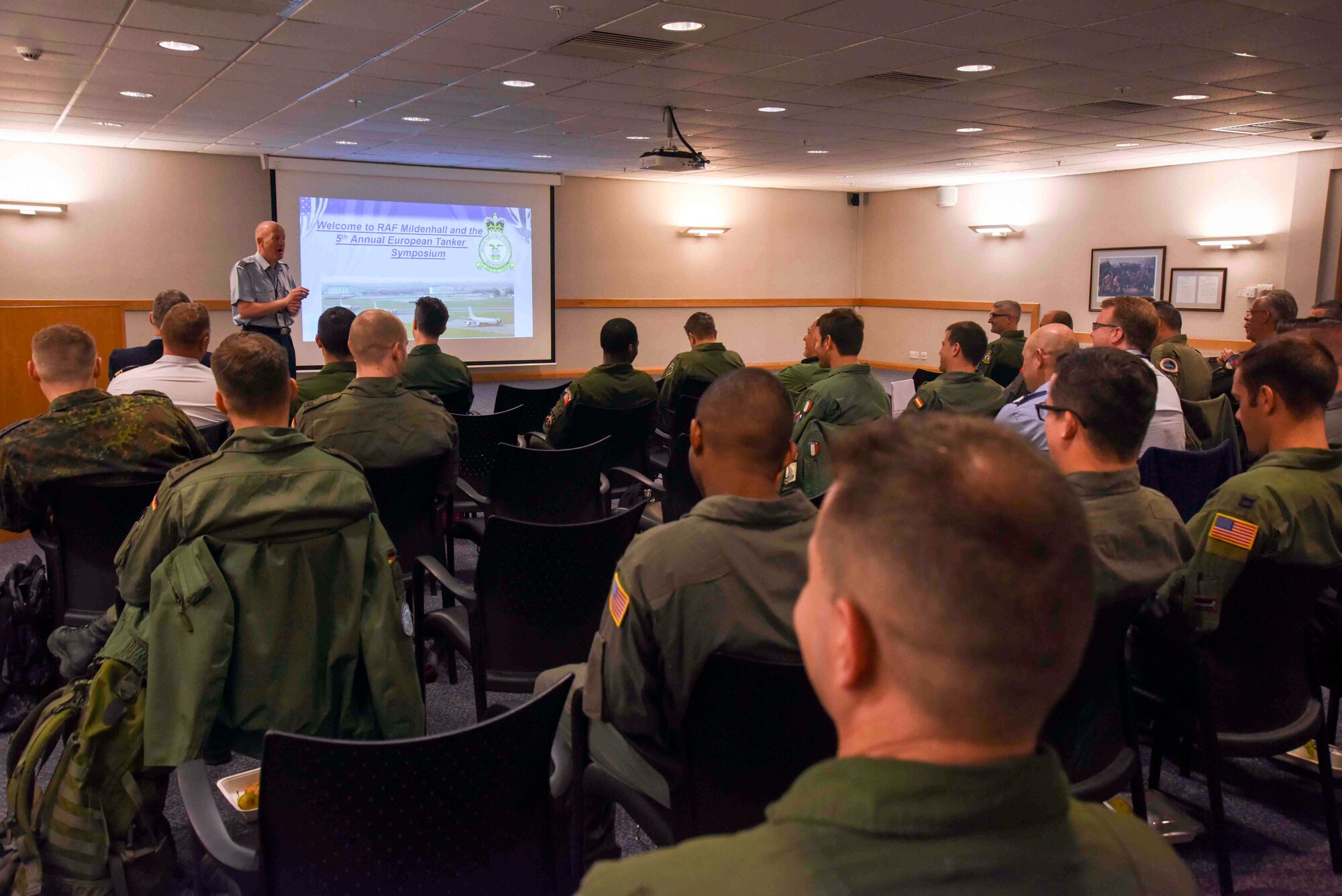 Sqn. Ldr. Richard Fryer, RAF Mildenhall station commander, welcomes aircrew on the first day of the European Tanker Symposium at RAF Mildenhall, England, May 14, 2018.  The 100th Air Refueling Wing hosted the 5th annual European Tanker Symposium, where 13 countries came together and trained to establish mixed-flight formation air refueling standardized procedures. (U.S. Air Force photo by Senior Airman Christine Groening)
