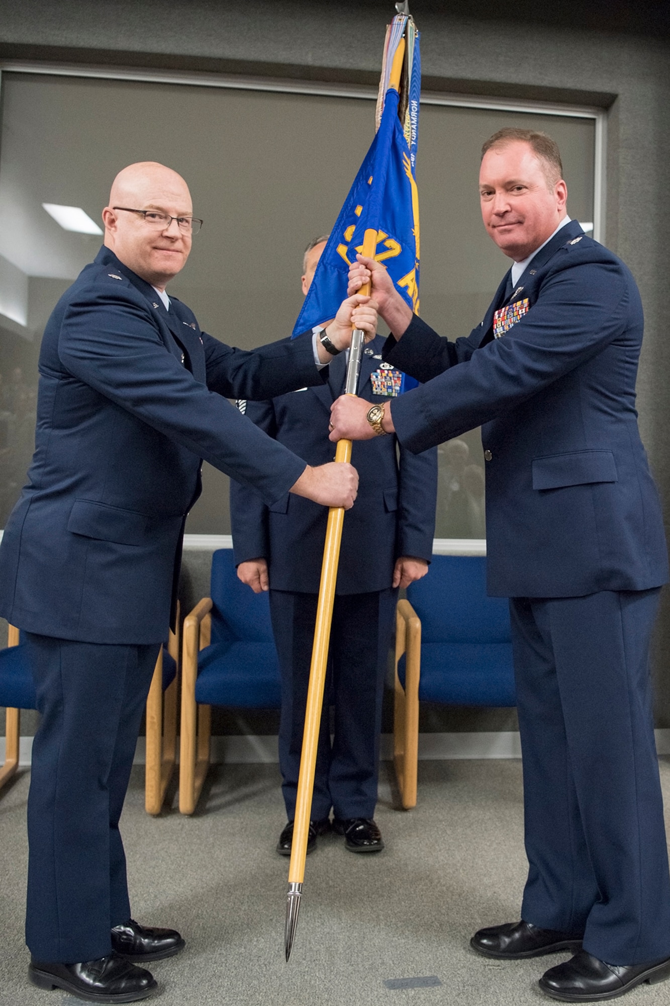 Lt. Col. Todd Moody, 434th Operations Group commander, left, passes the 72nd Air Refueling Squadron guidon to Lt. Col. Joe Austin as he takes command of the unit April 7, 2018 at Grissom Air Reserve Base, Ind. The 72nd ARS is one of two refueling squadrons assigned to the 434th Air Refueling Wing. (U.S. Air Force photo/Tech Sgt. Benjamin Mota)