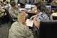 Members of one of four mission area working groups discuss the out-brief to be presented May 16, 2018, to about 1,000 senior leaders and Airmen from across the force. The out-brief concluded the 2018 Installation and Mission Support Weapons and Tactics Conference, held by the Air Force Installation and Mission Support Center, to research and develop innovative solutions for some of the Air Force's greatest agile combat support challenges. (U.S. Air Force photo by Armando Perez)