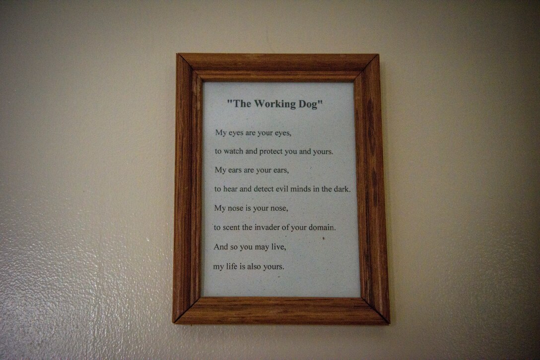 A picture frame displaying "The Working Dog", an ode from a military working dog to its handler, inside the base kennels at Patrick Air Force Base, Fla. The bond between a handler and an MWD is much deeper than most would think – as the two trust each other with their lives on a daily basis. (U.S. Air Force photo by Airman 1st Class Zoe Thacker)