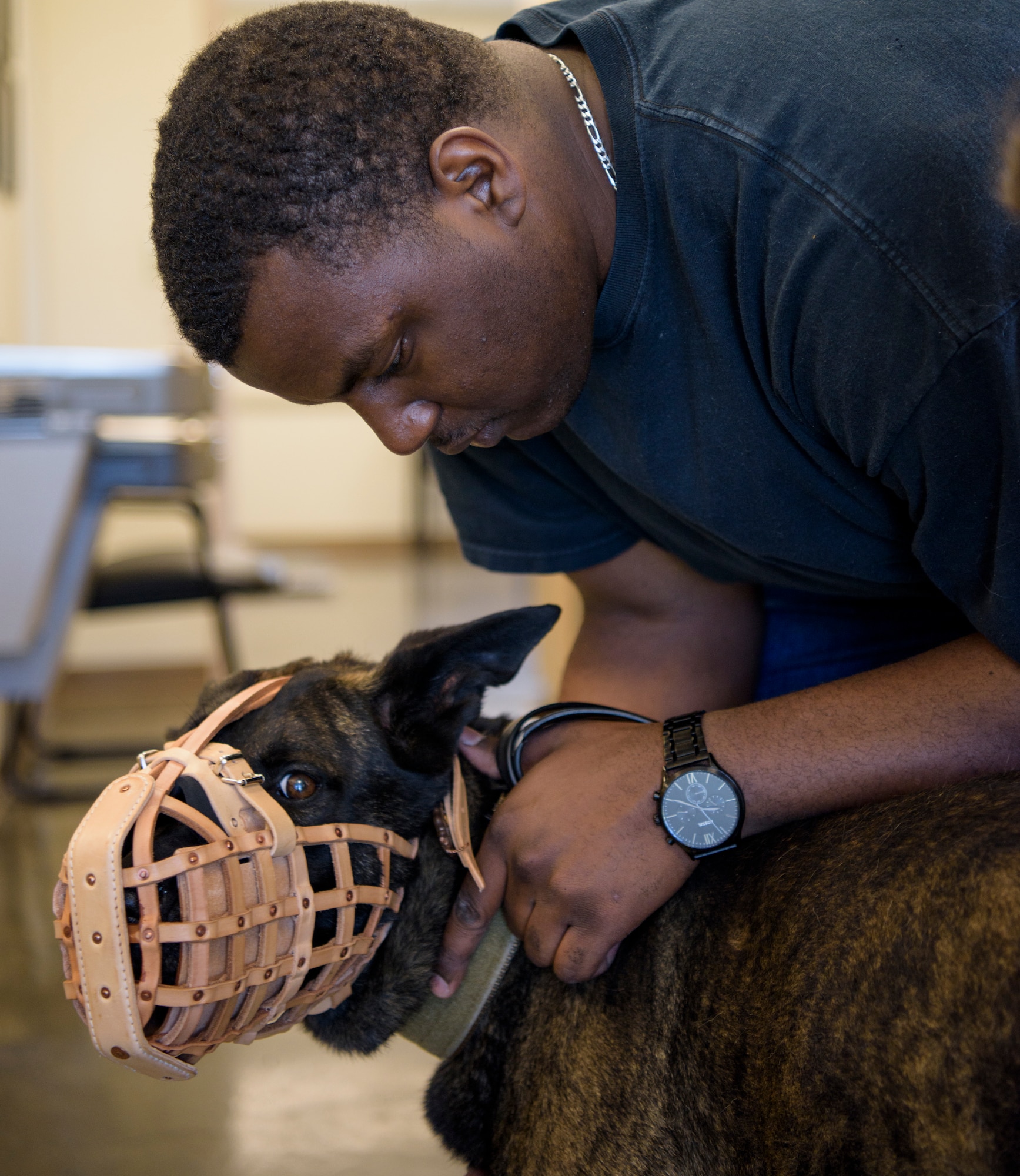 Senior Airman Antoine Carr calms military working dog Pieter during a veterinary appointment April 27, 2018 at Patrick Air Force Base's Veterinary Treatment center on Patrick Air Force Base, Fla. The appointment was considered routine, as all MWD's have to be examined after a deployment. (U.S. Air Force photo by Airman 1st Class Zoe Thacker)