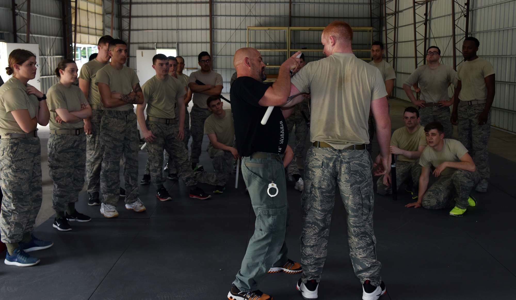 Billy Matheny, the senior combative instructor assigned to the 509th Security Forces Squadron, demonstrates a standing baton restraint technique to security forces Airmen May 15, 2018 at Whiteman Air Force Base, Mo.