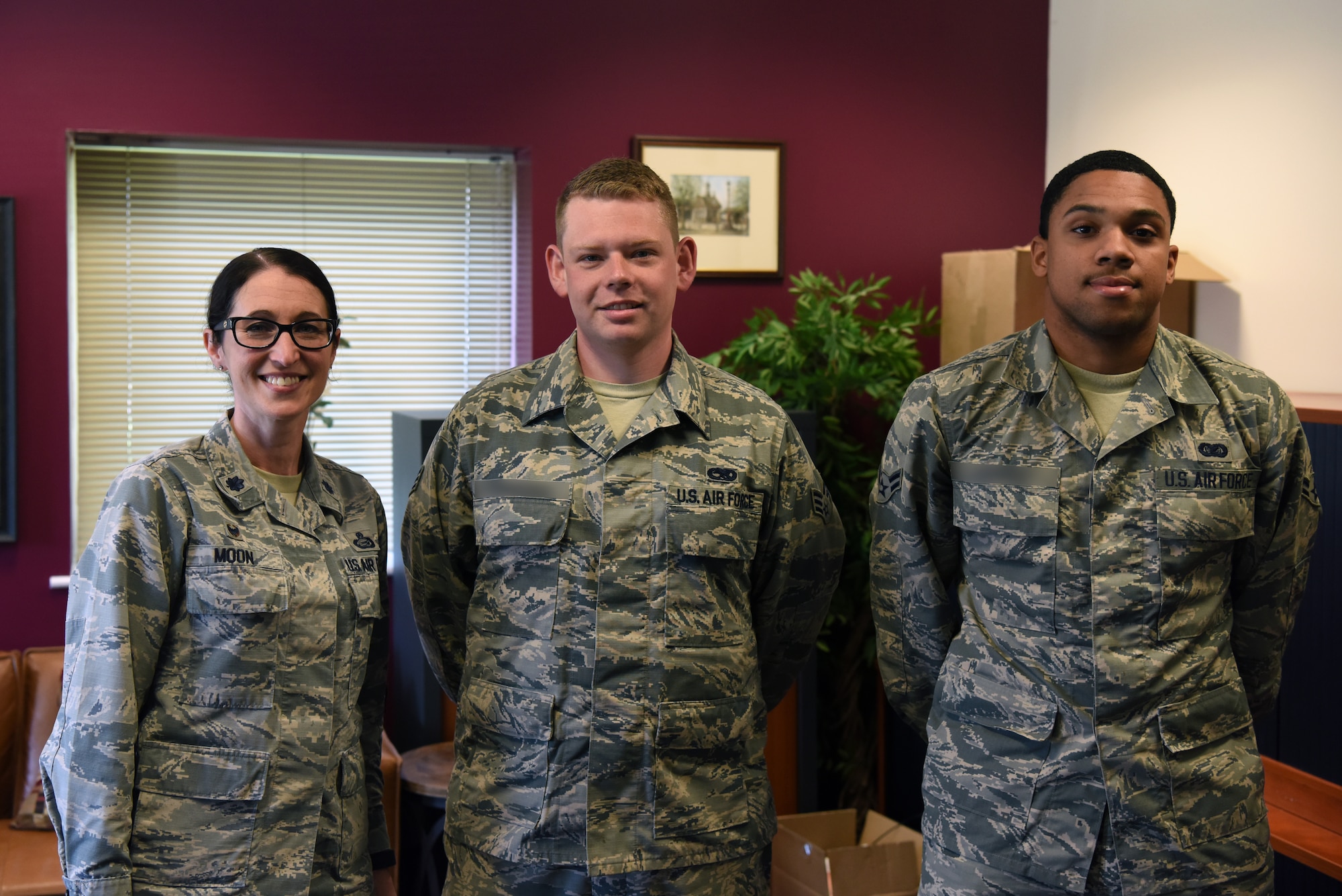 Lt. Col. Kelli R. Moon, commander of the 48th Force Support Squadron, poses with the two winning Airmen at the Airman & Family Readiness Center as part of the 48th Force Support Squadron's "You Got Served" events at Royal Air Force Lakenheath, England, May 8, 2018. During the event Lt. Col. Moon and civilians at the 48th Force Support Squadron Marketing section selected two Airmen to recieve a $10 gift card each. (U.S. Air Force Photo/ Airman 1st Class John A. Crawford)