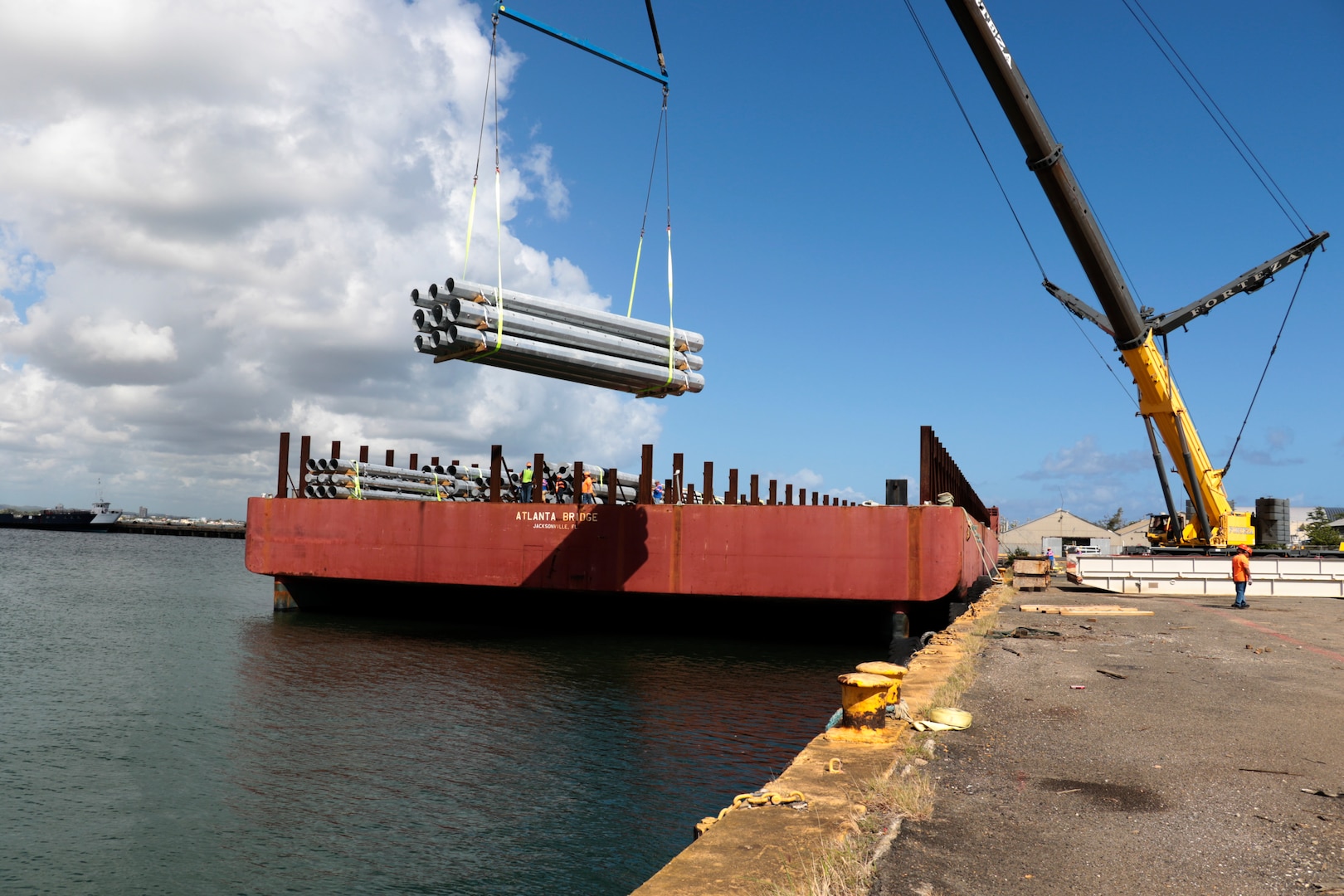 FEMA contractors unload utility poles from the barge Atlanta Bridge at Port of San Juan, Puerto Rico, May 2.