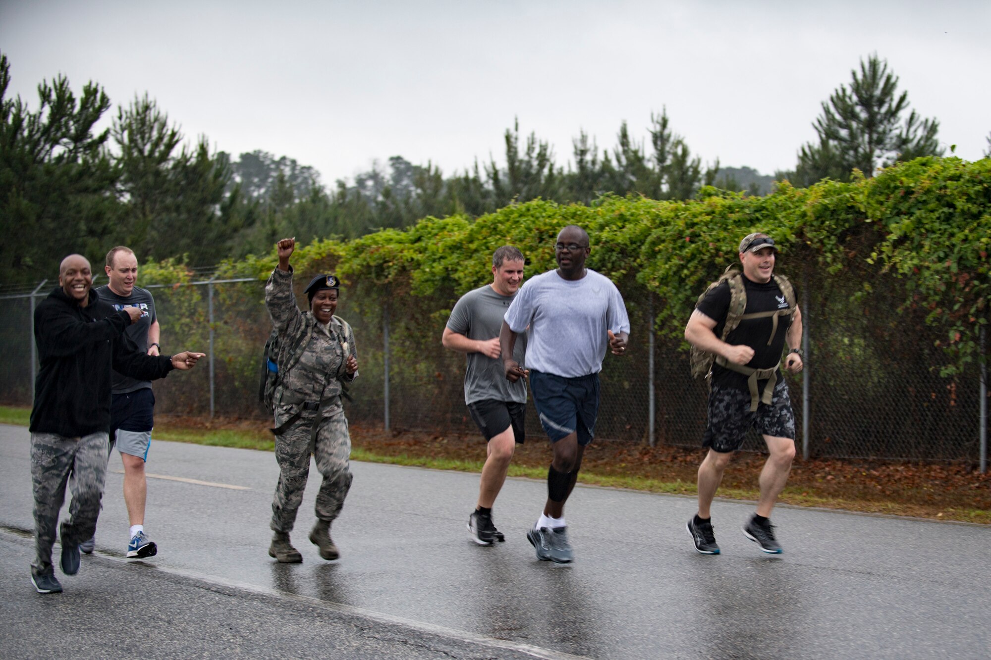 Members of the 23d Security Forces Squadron rush to the finish line of a Law Enforcement memorial 5k run and rucksack march, May 17, 2018, at Moody Air Force Base, Ga. President John F. Kennedy signed a proclamation in 1962 designating may 15 as Peace Officers Memorial Day.  Security Forces Members used Police Week to promote camaraderie and recognize all law enforcement members who have lost their lives in the line of duty. (U.S. Air Force photo by Senior Airman Daniel Snider)