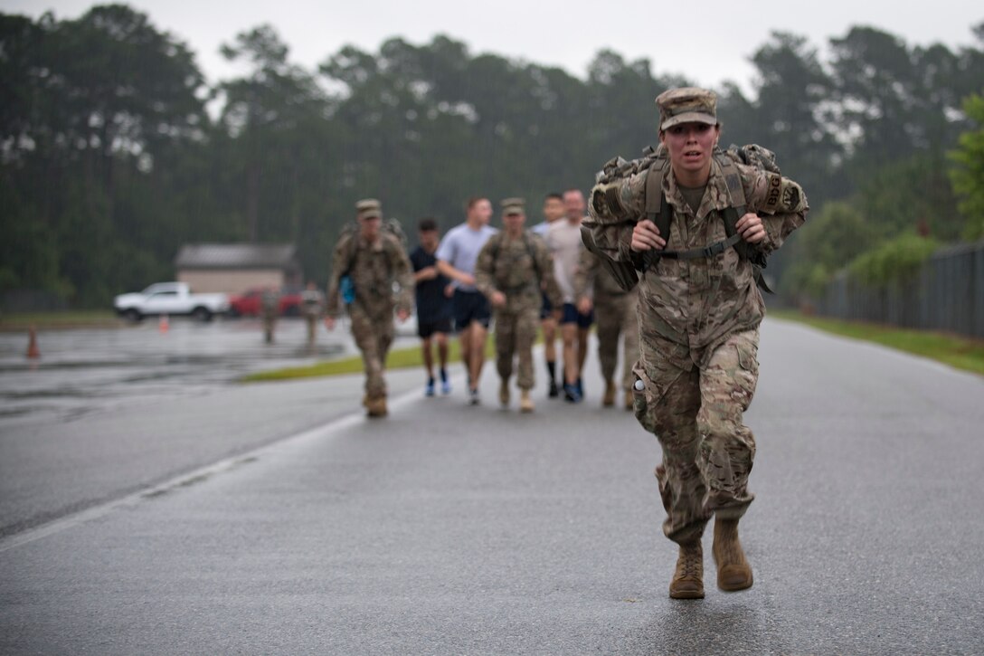 Staff Sgt. Elizabeth Patty, 820th command support staff member, carries her rucksack across the finish line of a Law Enforcement memorial 5k run and rucksack march, May 17, 2018, at Moody Air Force Base, Ga.Security Forces Members used Police Week to promote camaraderie and recognize all law enforcement members who have lost their lives in the line of duty. (U.S. Air Force photo by Senior Airman Daniel Snider)