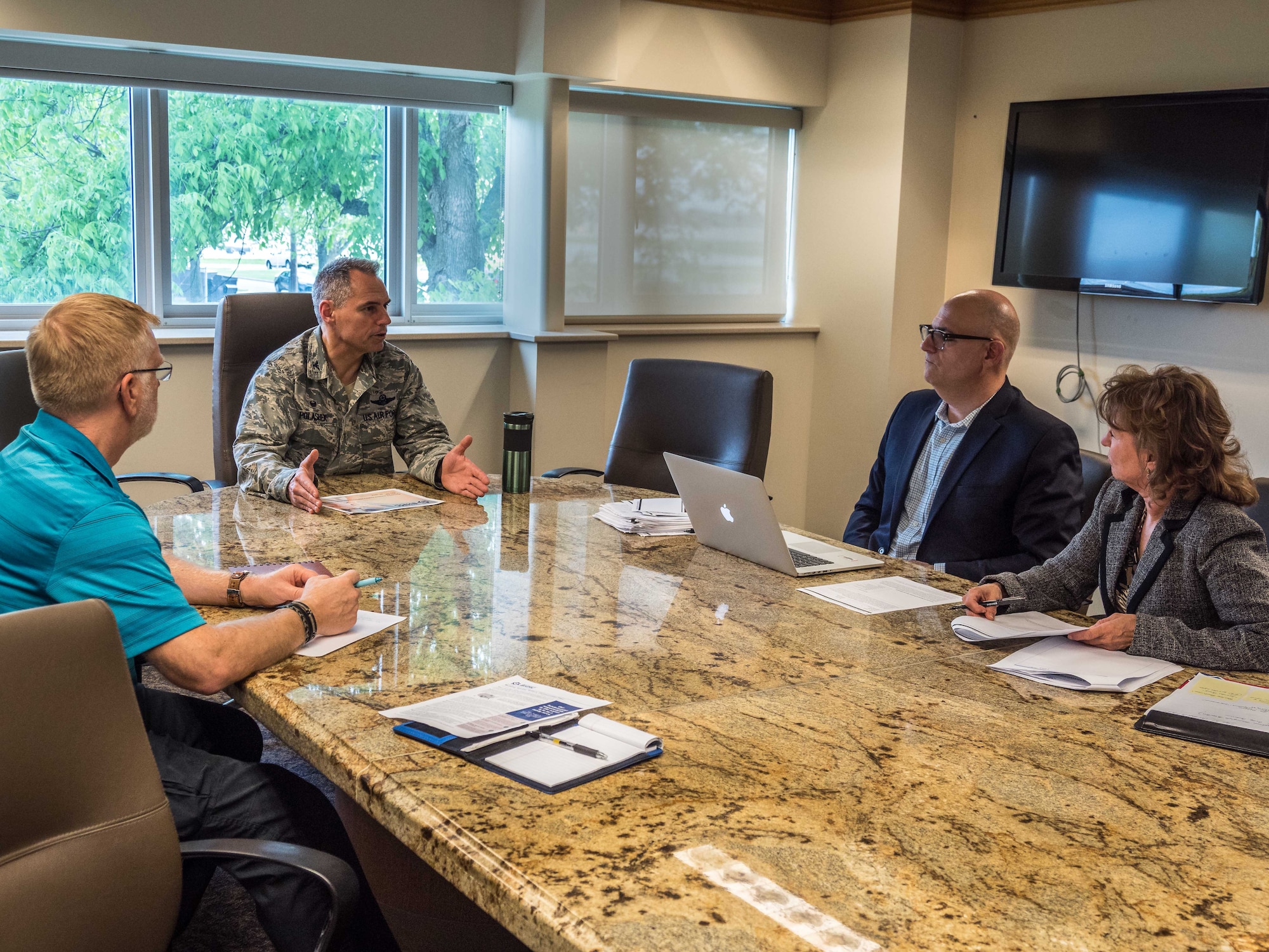 From left, Mike Sanford and Col. Tony Polashek meet with DoD stakeholders Salvadore Libretto and Cheryl Loft during Phase 1 of the BHMC Pilot May 17. (Air Force Photo/Paul Zadach)