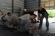 Billy Matheny, the senior combative instructor assigned to the 509th Security Forces Squadron, oversees a security forces team as they practice subduing and handcuffing a perpetrator May 15, 2018 at Whiteman Air Force Base, Mo.