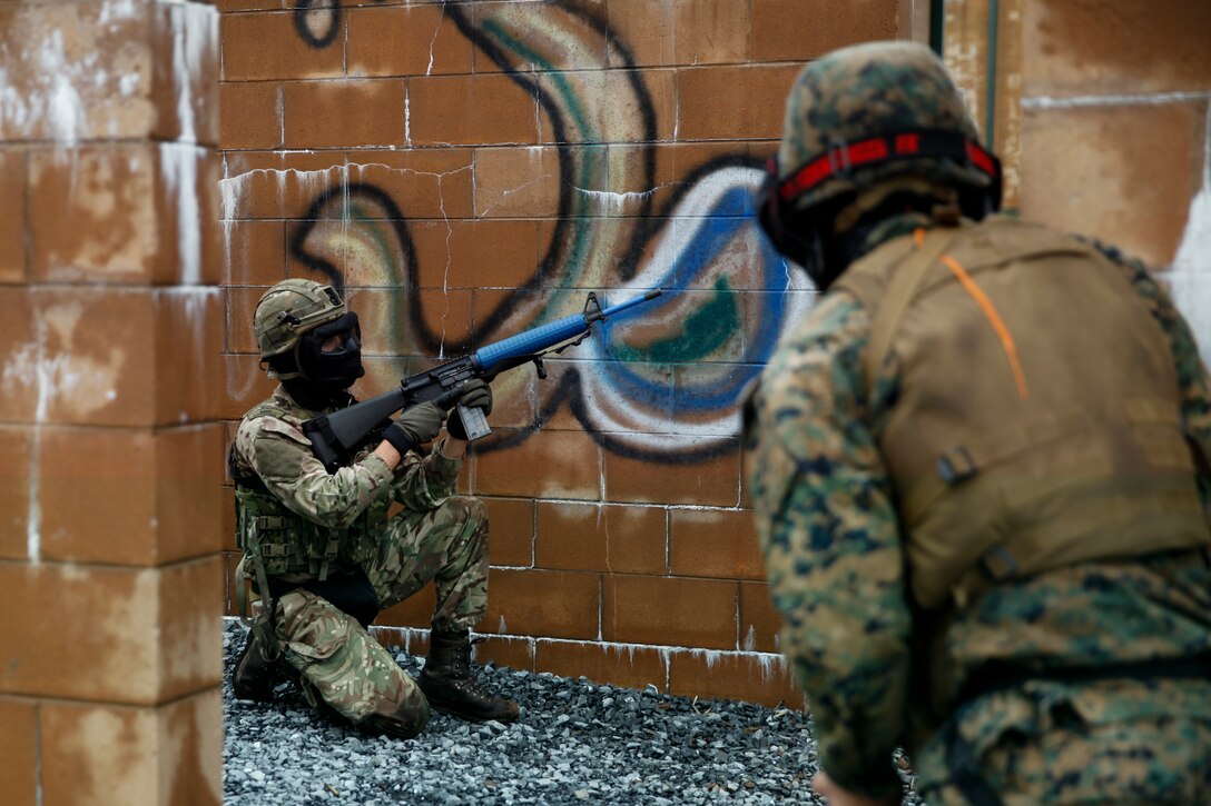 British Army Cpl. Thomas Matthews, commando with 131 Commando Squadron Royal Engineers, British Army,  sets security for his platoon of Marines with 6th ESB, 4th MLG and British commando’s with 131 Commando Squadron Royal Engineers, British Army, during a simulated live scenario at the military operations on urbanized terrain, or MOUT structure, during exercise Red Dagger at Fort Indiantown Gap, Pa., May 17, 2018.