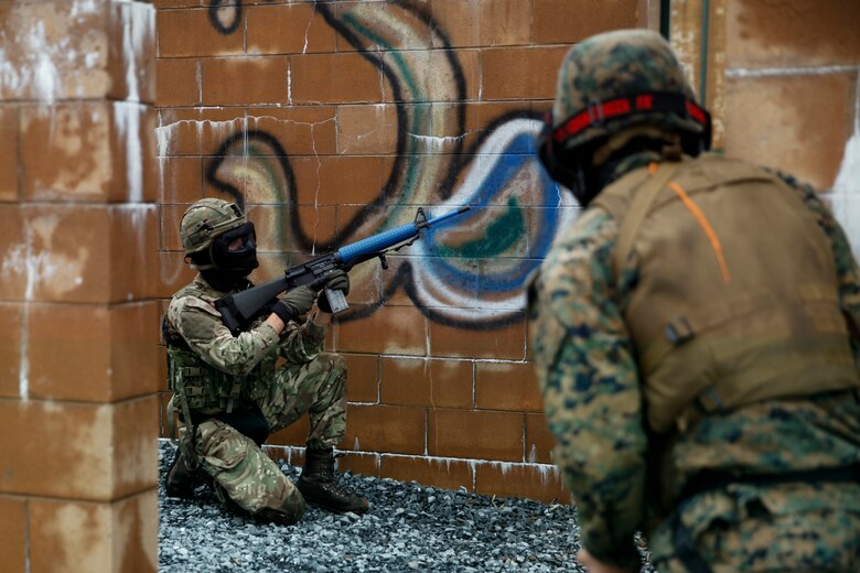 British Army Cpl. Thomas Matthews, commando with 131 Commando Squadron Royal Engineers, British Army,  sets security for his platoon of Marines with 6th ESB, 4th MLG and British commando’s with 131 Commando Squadron Royal Engineers, British Army, during a simulated live scenario at the military operations on urbanized terrain, or MOUT structure, during exercise Red Dagger at Fort Indiantown Gap, Pa., May 17, 2018.