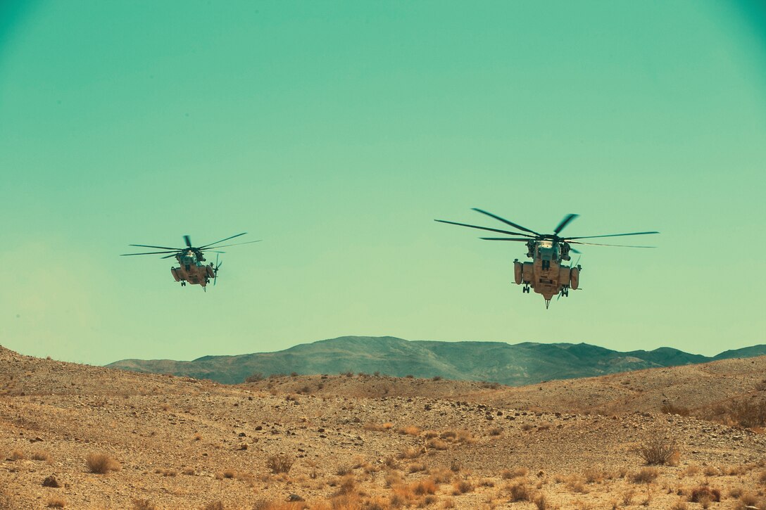 Two CH-53 Super Stallions prepare to land during an aerial assault course as part of Integrated Training Exercise 3-18 aboard the Marine Corps Air Ground Combat Center, Twentynine Palms, Calif., May 10, 2018. The purpose of ITX is to create a challenging, realistic training environment that produces combat-ready forces capable of operating as an integrated Marine Air Ground Task Force. (U.S. Marine Corps photo by Lance Cpl. Isaac Cantrell)