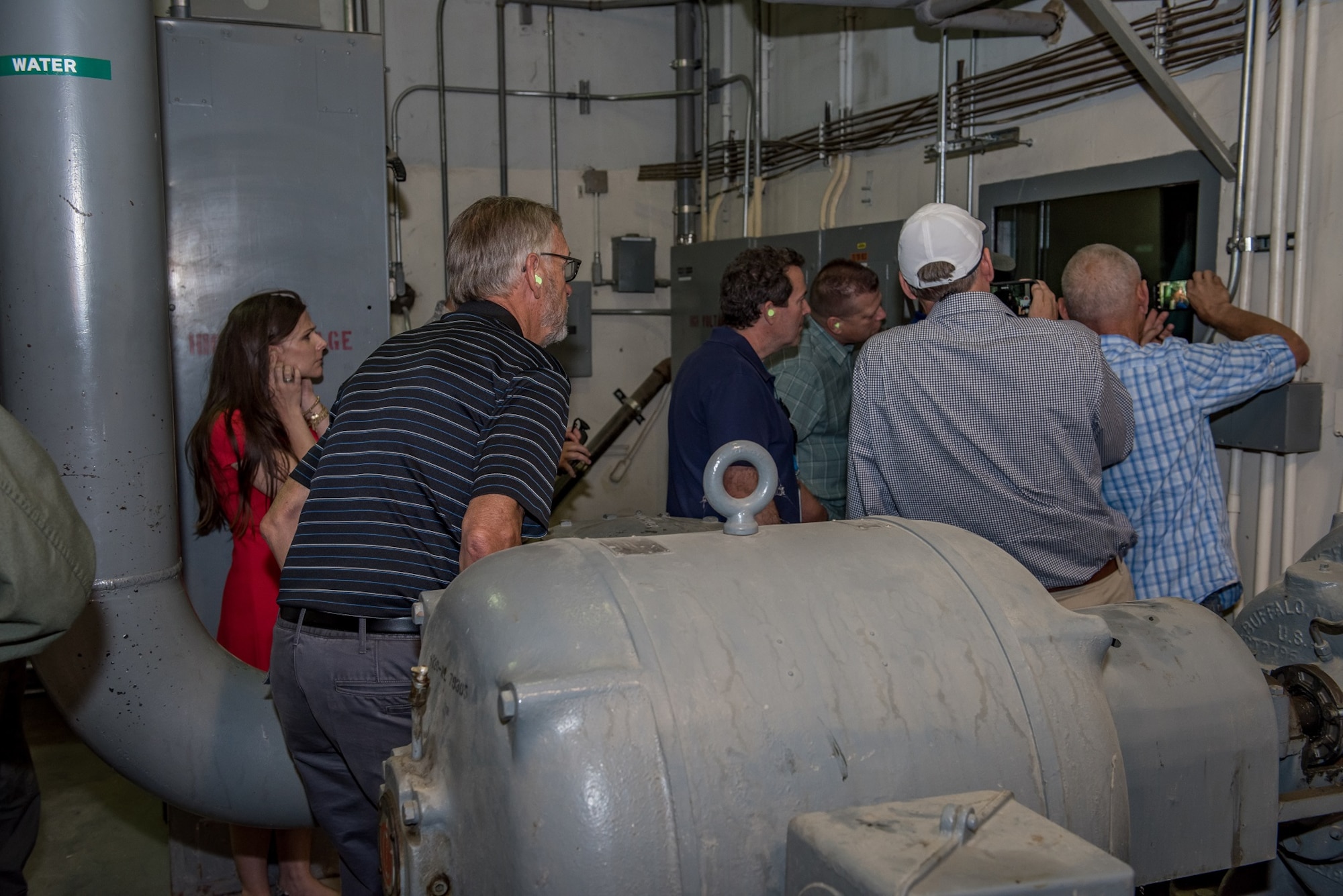 Honorary commanders watch a test run of a jet engine. Engines are run in the test cell facility to determine if there is a problem before and after maintenance is conducted to ensure all problems have been corrected before being reinstalled on an airplane. (U.S. Air Force photo by Matt Williams)
