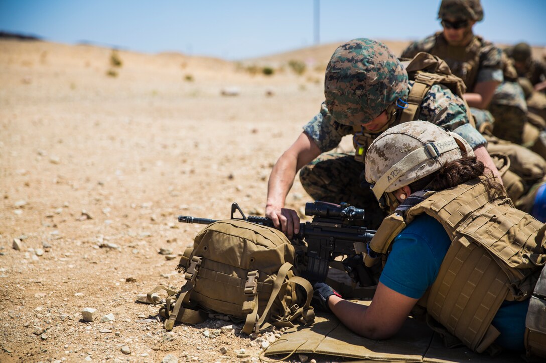 A Combat Logistics Battalion 7 spouse fires an M16A4 service rifle during the unit’s Jane Wayne Day aboard the Marine Corps Air Ground Combat Center, Twentynine Palms, Calif., May 10, 2018. Jane Wayne Day gave the spouses a glimpse into the day-to-day lives of their active duty spouses through the combat convoy simulator, a live-fire range and a combat fitness test. (U.S. Marine Corps photo by Lance Cpl. Margaret Gale)