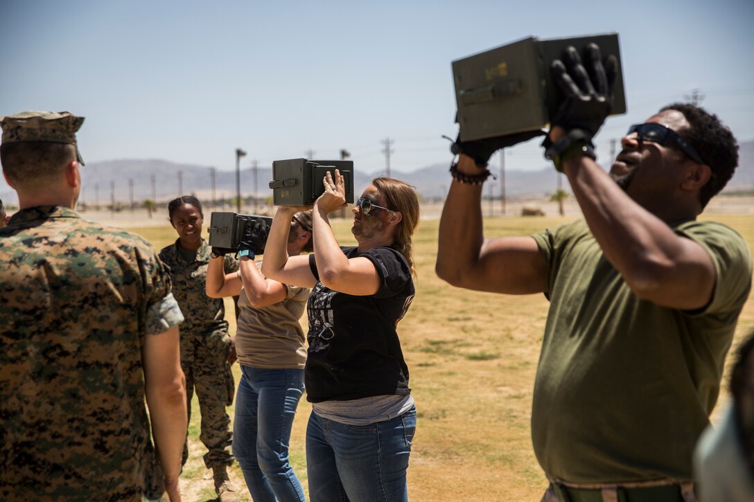 Spouses and family members of Marines with Combat Logistics Battalion 7 perform ammo can lifts during a combat fitness test for the unit’s Jane Wayne Day aboard the Marine Corps Air Ground Combat Center, Twentynine Palms, Calif., May 10, 2018. Jane Wayne Day gave the spouses a glimpse into the day-to-day lives of their active duty spouses through the combat convoy simulator, a live-fire range and a combat fitness test. (U.S. Marine Corps photo by Lance Cpl. Margaret Gale)