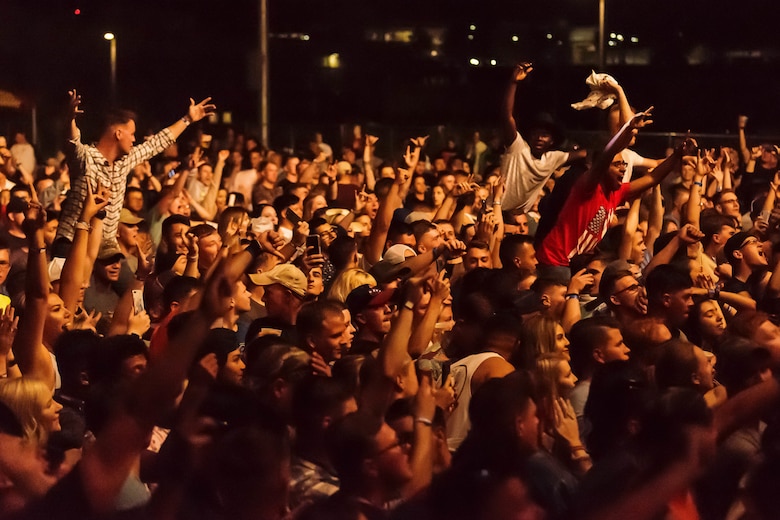 The crowd at the 15th annual We Salute You Celebration cheers on  Canaan Smith during his set aboard the Marine Corps Air Ground Combat Center, Twentynine Palms, Calif., May 12, 2018. The annual event is held to thank military members aboard the Combat Center for their service and featured a free live music concert, games, activities, food and beverages. (U.S. Marine Corps photo by Lance Cpl. Rachel K. Porter)