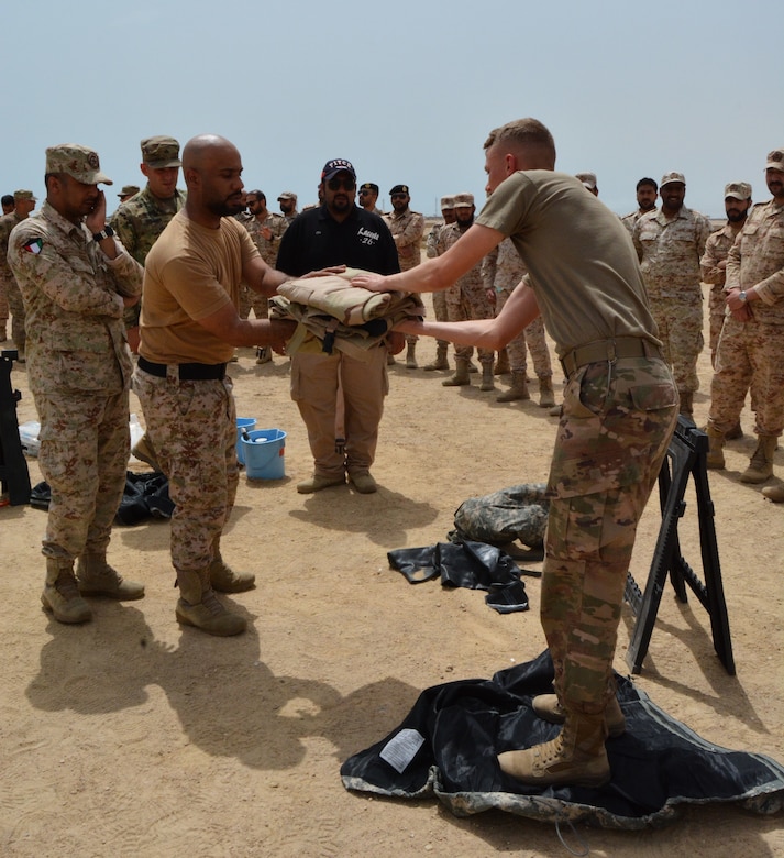 More than 45 U.S. and Kuwait Land Forces soldiers share Tactics, Techniques, and Procedures (TTP) of Mission Oriented Protective Posture (MOPP) gear exchange, as well as vehicle decontamination procedures during a joint partner training opportunity, April 25, 2018.