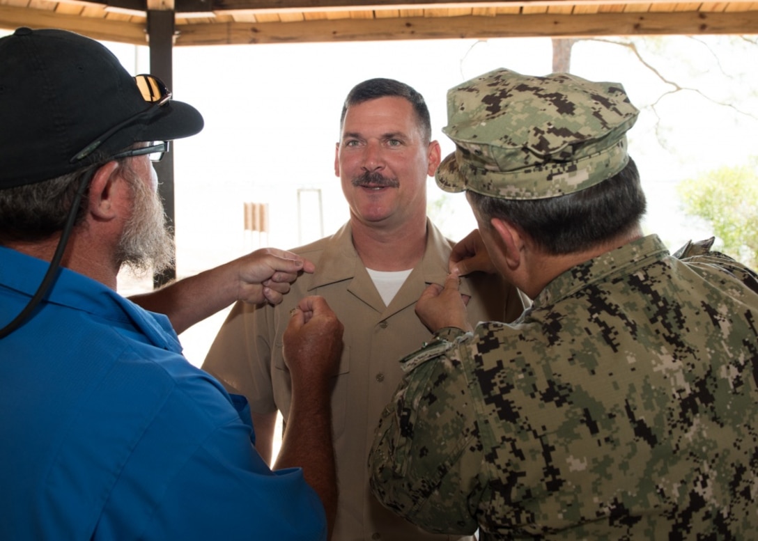 Jesse Waymire, an engineer at the Naval Surface Warfare Center Panama City Division, explains testing and evaluation procedures of diving equipment during a tour attended by Texas A&M students recently. Professor Dr. Thomas Iliffe, pictured center, travelled with his introduction to scientific diving students to tour the Division to help them gain a better insight into careers and technologically advanced diving capabilities. (RELEASED) U.S. Navy photo by Susan H. Lawson