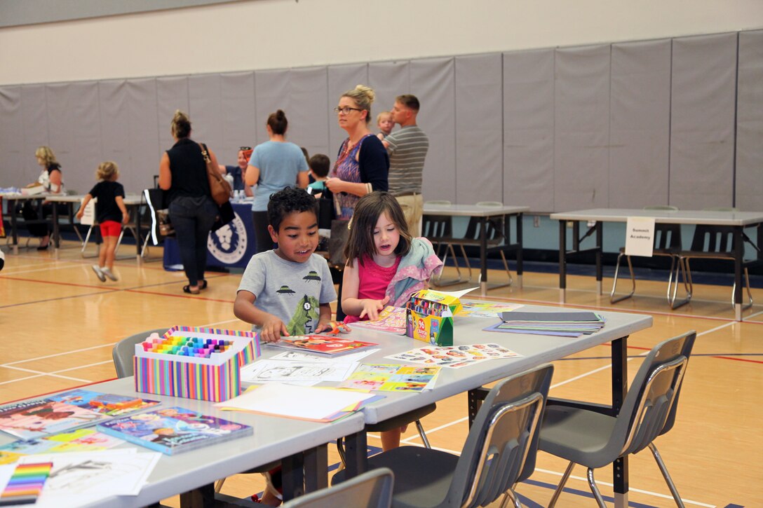 Young attendees of the Combat Center School Liaison Kindergarten Parent Transition Workshop color while their parents gather information May 9, 2018. The event at the MCCS Community Center aboard Marine Corps Air Ground Combat Center, Twentynine Palms, Calif., drew 38 parents and 32 children. (U.S. Marine Corps photo by Kelly O'Sullivan)