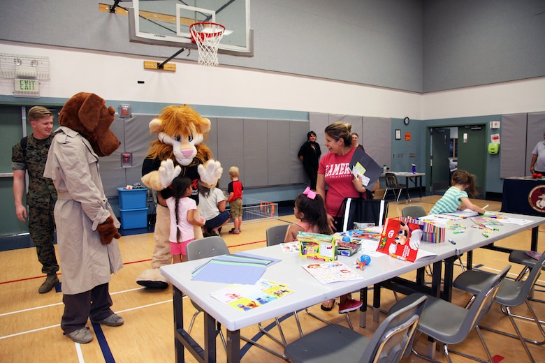 McGruff the Crime Dog and Daren the DARE Lion interact with family members attending the Combat Center School Liaison's annual Kindergarten Parent Transition Workshop, May 9, 2018. The event at the MCCS Community Center aboard Marine Corps Air Ground Combat Center, Twentynine Palms, Calif., drew 38 parents and 32 children. (U.S. Marine Corps photo by Kelly O'Sullivan)