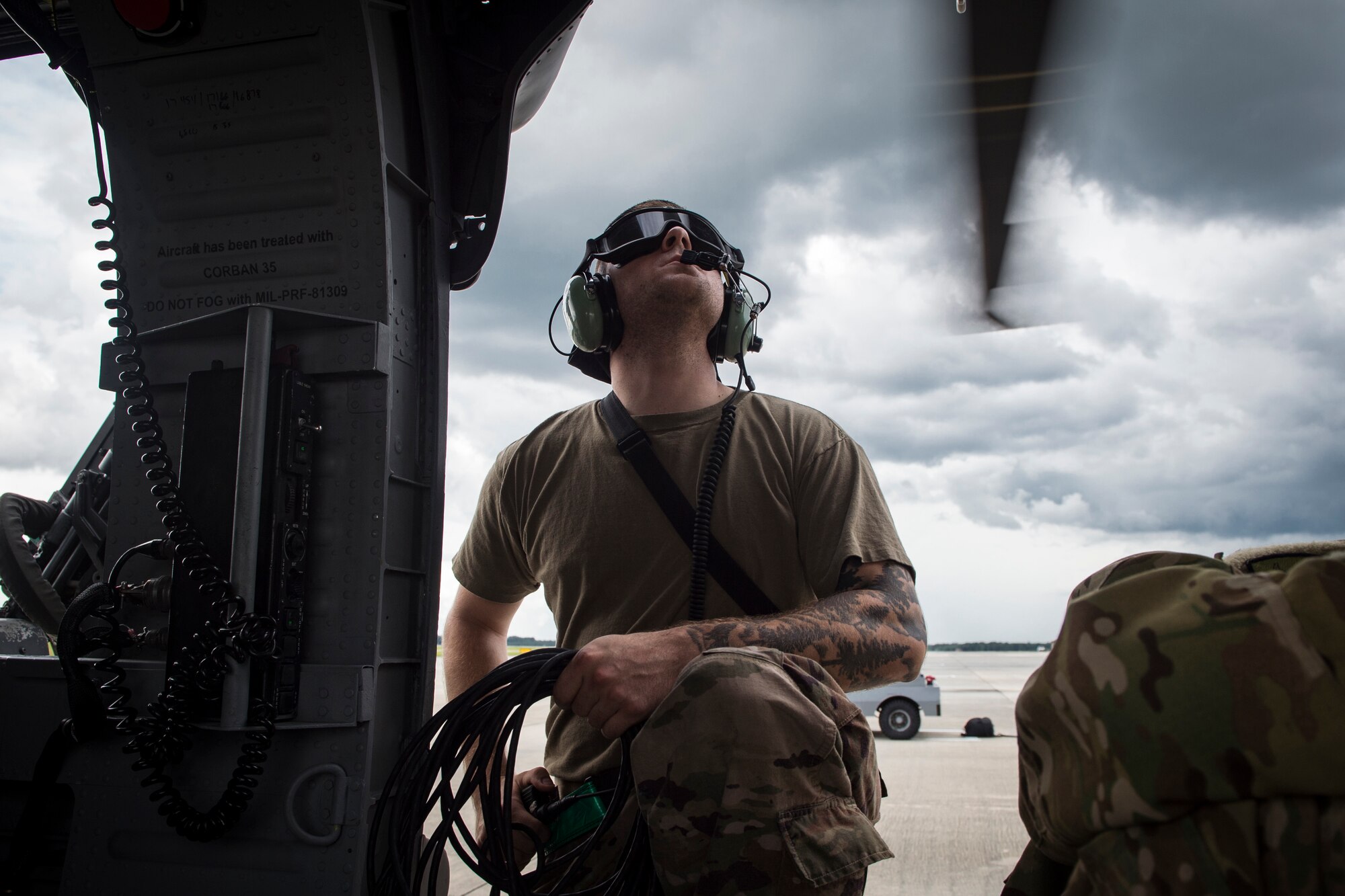 Airman 1st Class Joshua Costello, 723d Aircraft Maintenance Squadron crew chief, watches the propellers of an HH-60G Pave Hawk rotate prior to launching the aircraft, May 17, 2018, at Moody Air Force Base, Ga. Airmen conduct routine training missions in the airspace surrounding Moody to remain current on their tactics and procedures. While helping pilots remain proficient, training also gives crew chiefs and maintainers the opportunity to remain proficient at launching and maintaining the aircraft. (U.S. Air Force photo by Senior Airman Janiqua P. Robinson)