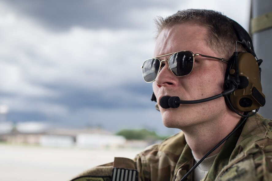 Senior Airman Ethan Aarness, 41st Rescue Squadron special missions aviator, watches a preflight inspection before a HH-60G Pave Hawk launch May 17, 2018, at Moody Air Force Base, Ga. Airmen conduct routine training missions in the airspace surrounding Moody to remain current on their tactics and procedures. While helping pilots remain proficient, training also gives crew chiefs and maintainers the opportunity to remain proficient at launching and maintaining the aircraft. (U.S. Air Force photo by Senior Airman Janiqua P. Robinson)