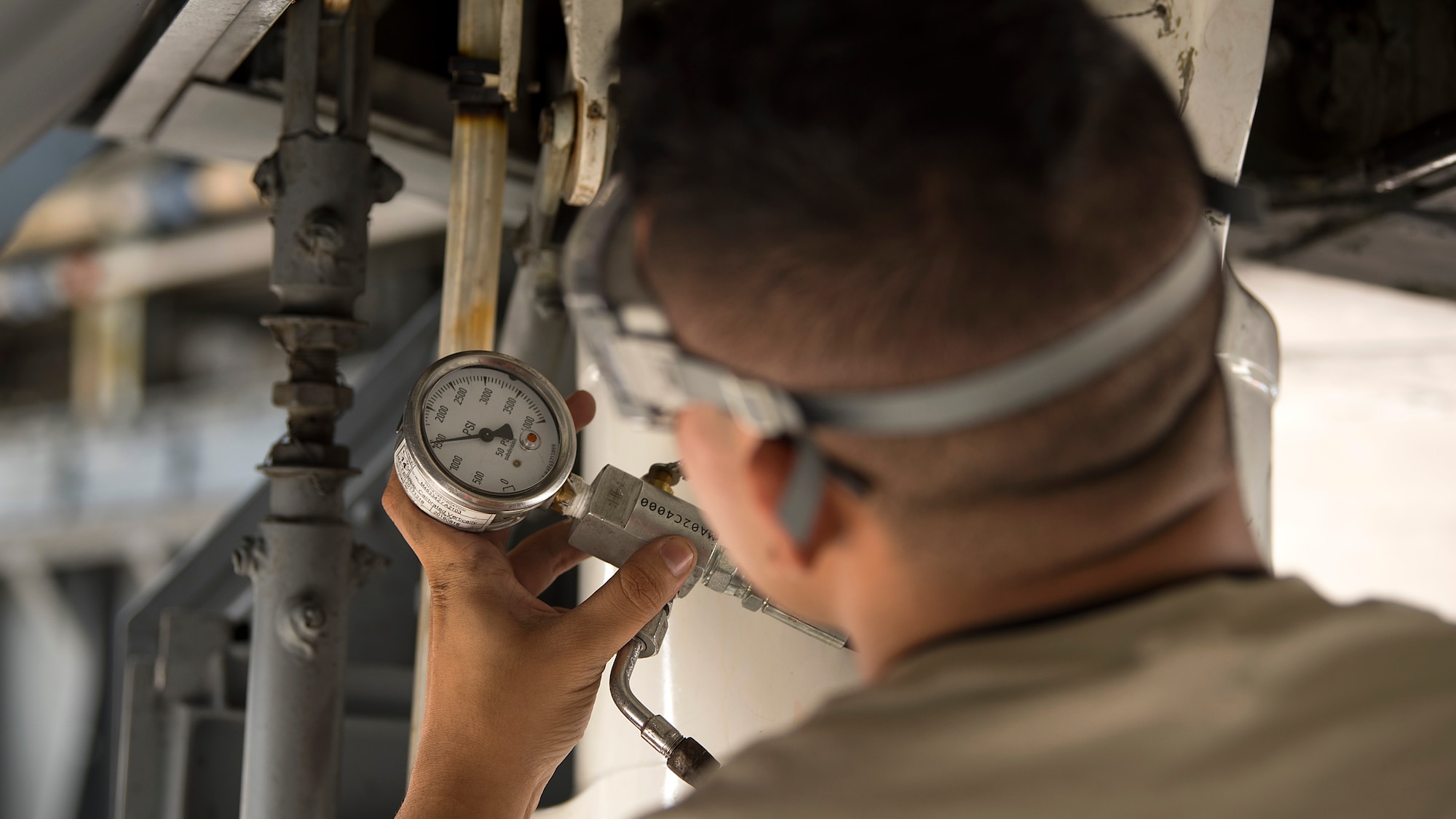 A maintenance Airman checks the pressure of a hydraulic system during a 900-hour inspection at MacDill Air Force Base, Fla., May 16, 2018. This inspection occurs after an aircraft has flown 900 hours. MacDill’s contribution to global mobility is possible because of the maintenance Airmen who dedicate countless hours to ensure aircraft are fit for flight.