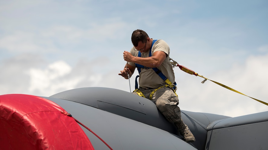 An aircraft maintenance crewmember screws a panel on top of a KC-135 Stratotanker aircraft during a 900-hour inspection at MacDill Air Force Base, Fla., May 16, 2018. This inspection occurs after an aircraft has flown 900 hours. MacDill’s contribution to global mobility is possible because of the maintenance Airmen who dedicate countless hours to ensure aircraft are fit for flight.