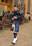 Officer plays bagpipe