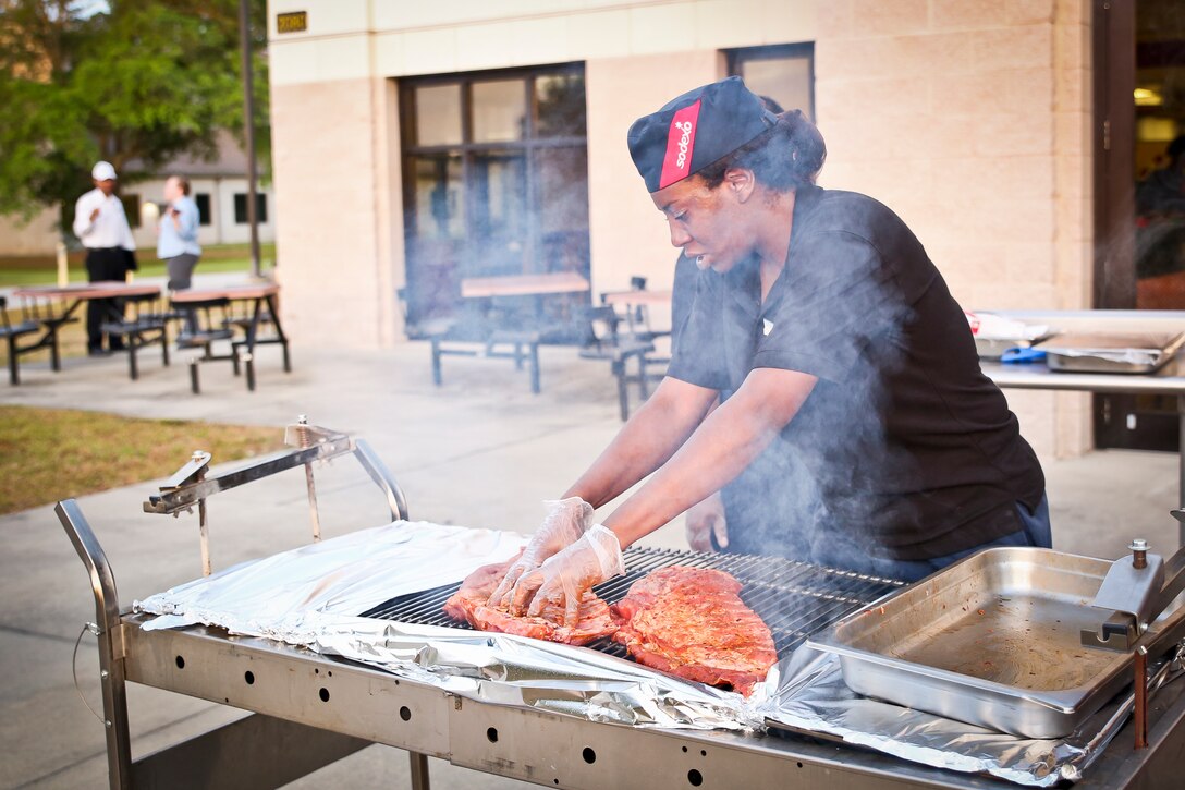 Vanessa Love competes in the quarterly cook off aboard the Marine Corps Air Station Beaufort May 16. The theme for this cook off was Pit Masters. Each team prepared a plate of BBQ samples for the judges. The competition served to foster camaraderie and sharpen the skills of food service Marines and Sodexo workers. Love is a chief cook with Sodexo, MCAS Beaufort.