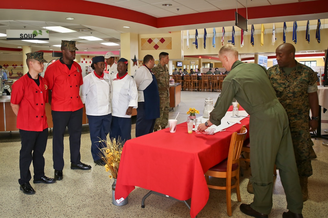 Teams of chefs await the judge’s decision during the quarterly cook off aboard Marine Corps Air Station Beaufort May 16. The theme of this cook off was Pit Masters. Each team prepared a plate of BBQ for the judges. The competition served to foster camaraderie and sharpen the skills of food service Marines and Sodexo workers. The teams are with MCAS Beaufort and Marine Corps Recruit Depot Parris Island.