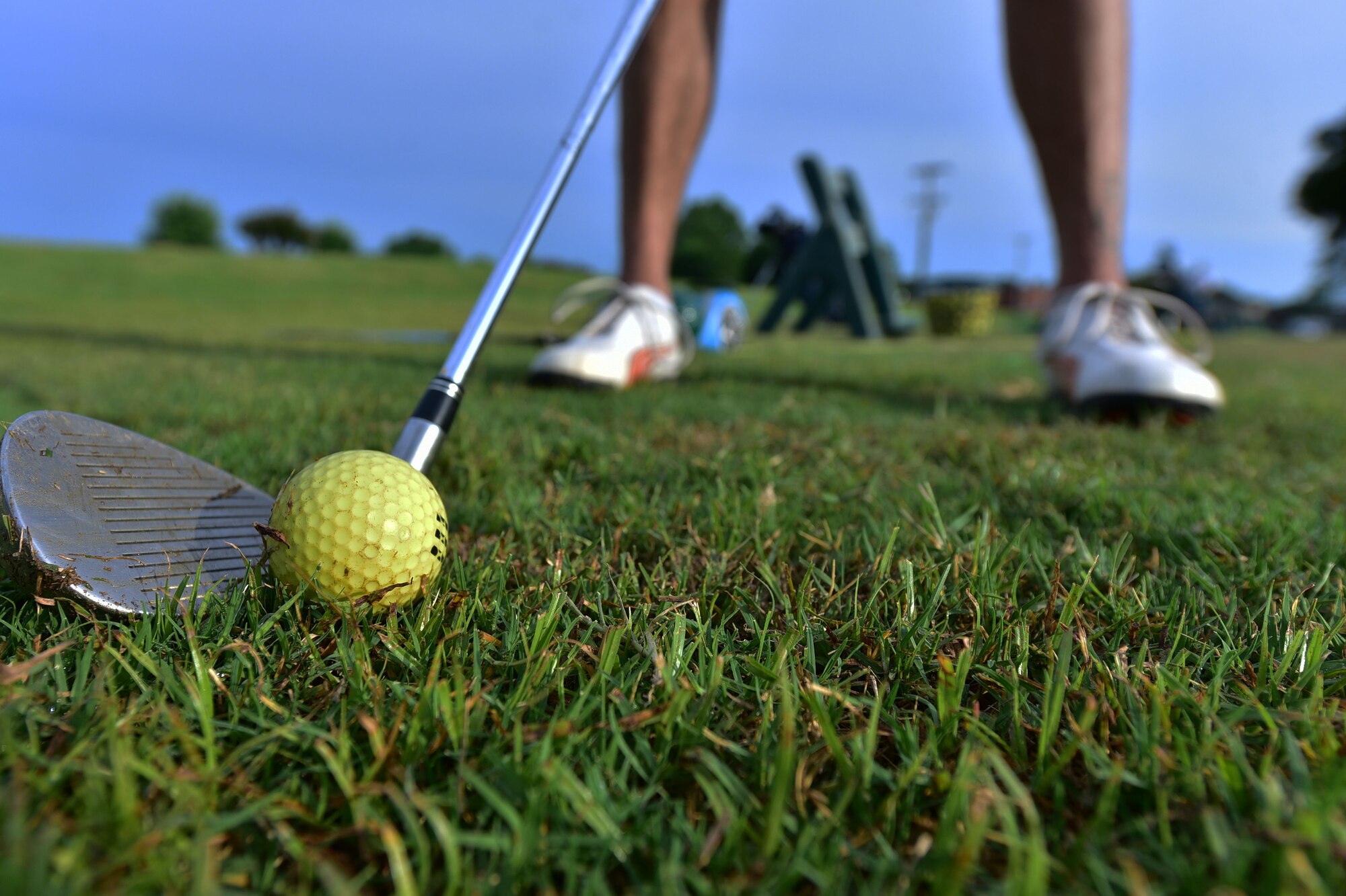 Man prepares for golf swing.