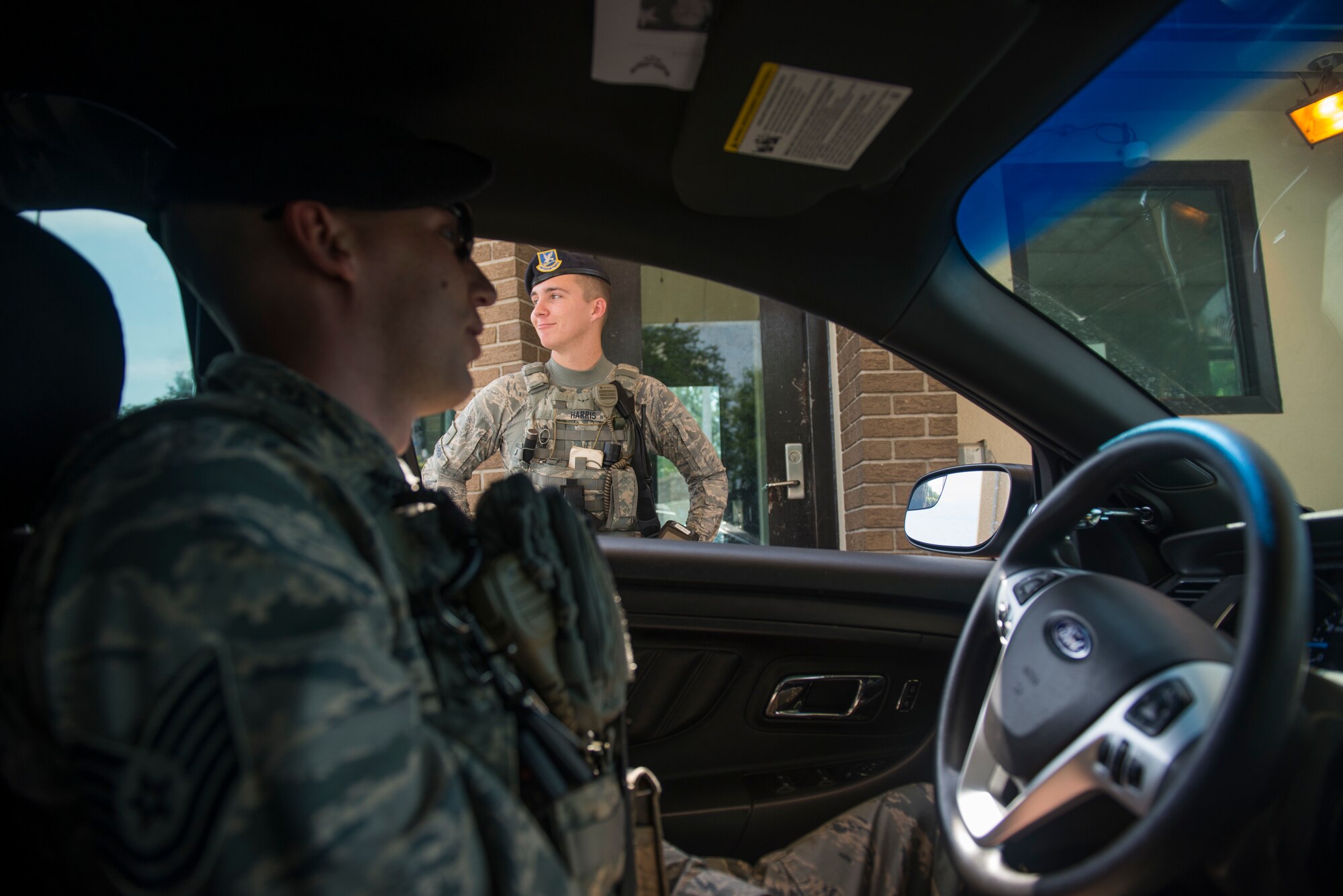Tech. Sgt. Jarrod Kinard, 81st Security Forces Squadron flight chief, checks in on Airman Hunter Harris, 81st SFS entry controller, during a ride-along at Keesler Air Force Base, Miss., May 17, 2018. The ride-along program is part of the 81st SFS community involvement initiative where anyone, age 15 and up and with base access, can see what it's like to be a defender. If you are interested in the ride-along program, please contact Tech. Sgt. Matthew Oleson at 228-376-6601. (U.S. Air Force photo by Senior Airman Travis Beihl)