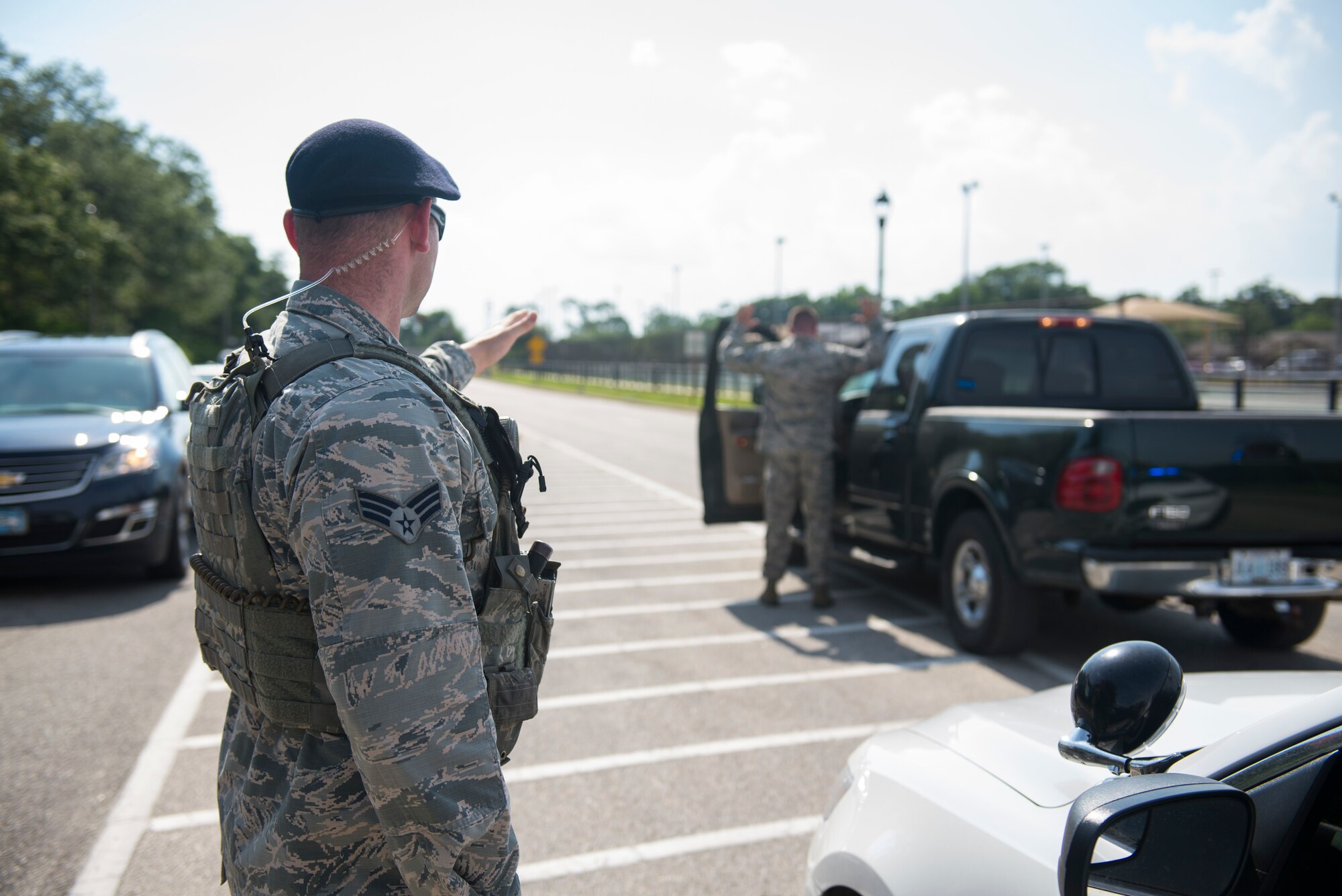 Senior Airman Zachary Vega, 81st Security Forces Squadron instillation patrolman, takes control of a role player during an exercise situation at a gate during a ride-along at Keesler Air Force Base, Miss., May 17, 2018. The ride-along program is part of the 81st SFS community involvement initiative where anyone, age 15 and up and with base access, can see what it's like to be a defender. If you are interested in the ride-along program, please contact Tech. Sgt. Matthew Oleson at 228-376-6601. (U.S. Air Force photo by Senior Airman Travis Beihl)