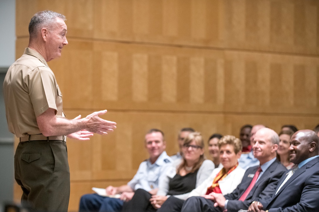 The chairman of the joint chiefs of staff speaks on stage.