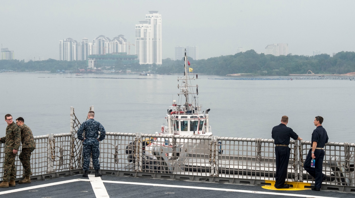 Sailors and Marines observe as USNS Millinocket (T-EPF 3) departs Singapore. USNS Millinocket is supporting a U.S. 7th Fleet theater security cooperation mission and will be traveling to several Indo-Pacific countries in the coming weeks.