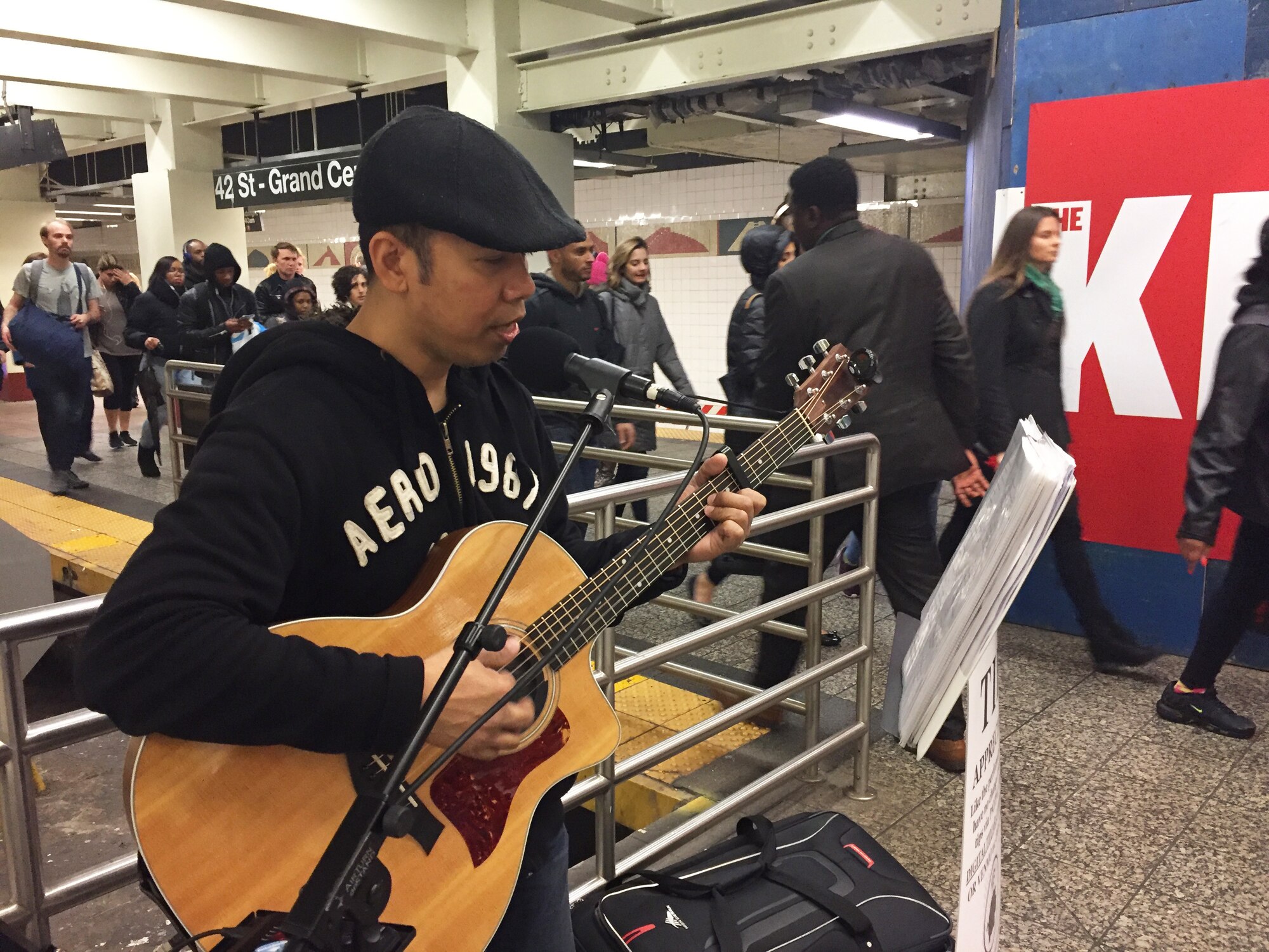 U.S. Tech. Sgt. Oliver Dagum sings and plays guitar by the S train at Grand Central Station, New York, New York. Dagum is a Ramp Services Supervisor at the 88th Aerial Port Squadron, 514th Air Mobility Wing, Joint Base McGuire-Dix-Lakehurst, New Jersey. (U.S. Air Force photo by 1st Lt. Emily Rautenberg)