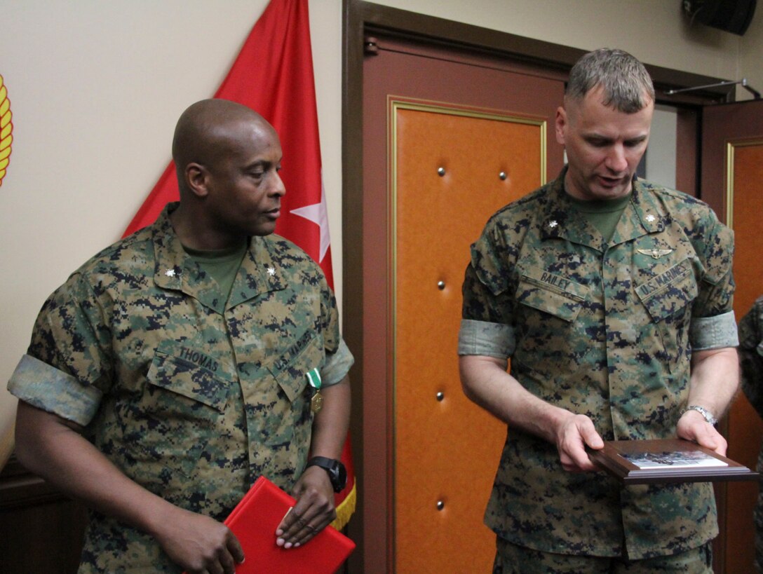U.S. ARMY GARRISON, YONGSAN – Lt. Col. Larry A. Bailey (right), U.S. Marine Corps Forces Korea G3 operations officer, presents a going-away plaque to Lt. Col. Daniel J. Thomas, MARFORK G3 future operations officer, for his time and efforts with the unit here, May 11.  Thomas, who detached and will report to 4th Marines, also received a Navy and Marine Corps Commendation Medal for his contributions to the unit as director for MARFORK future operations and his leadership in MARFORK’s future move to Camp Humphreys. (U.S. Marine Corps photo by Sgt. Nathaniel Hanscom/Released)